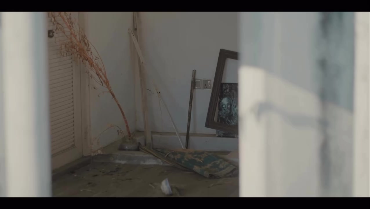 An abandoned room with a fallen painting