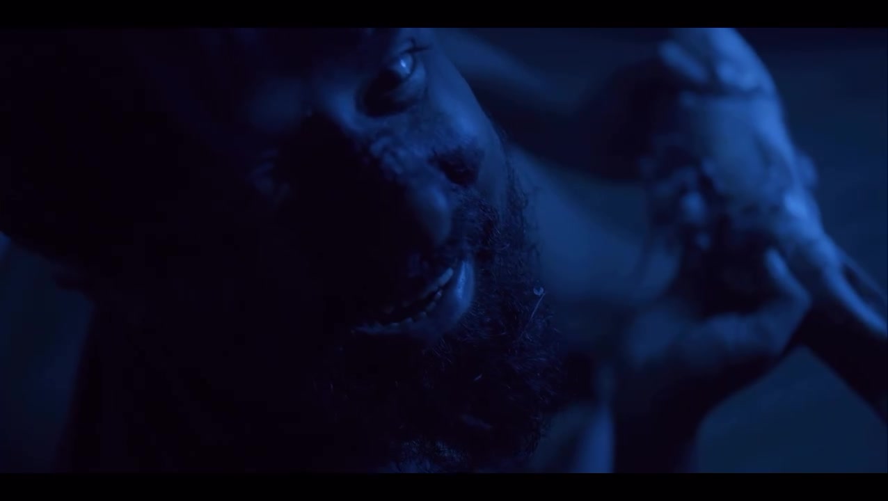 A face lit in cold blue, eyes wide